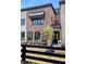 Beautiful brick home with large windows, a small tree, and black trim accents throughout the exterior at 11896 Spring Mill Rd, Carmel, IN 46032