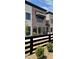 Modern brick townhome with black window trim, and a dark wooden fence bordering the front yard at 11896 Spring Mill Rd, Carmel, IN 46032