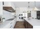 Bright kitchen features white cabinetry, quartz countertops, and stainless steel appliances at 11896 Spring Mill Rd, Carmel, IN 46032