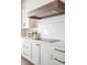 Close up of kitchen details including quartz counters, glass cooktop, and dark hardware at 11896 Spring Mill Rd, Carmel, IN 46032