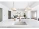 Kitchen island with a sink, faucet, and two pendant lights at 11896 Spring Mill Rd, Carmel, IN 46032