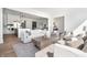 Bright and airy living room open to the kitchen with hardwood floors, white sofas, and a neutral rug at 11896 Spring Mill Rd, Carmel, IN 46032