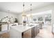 Open concept kitchen featuring an island with the dining and living area in view at 11896 Spring Mill Rd, Carmel, IN 46032