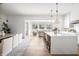 Bright open-concept kitchen and living space with a large kitchen island and hardwood floors at 11896 Spring Mill Rd, Carmel, IN 46032