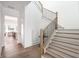 Beautiful staircase with hardwood steps, modern railing, and views into the living area at 11896 Spring Mill Rd, Carmel, IN 46032