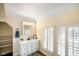Bright bathroom featuring a vanity with built in storage, sink, mirror and natural light from the window at 232 N Church St, Morgantown, IN 46160