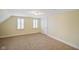 Attic bonus room with neutral carpet flooring and naturally-lit windows at 232 N Church St, Morgantown, IN 46160