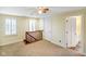 Cozy upstairs bedroom bathed in natural light with ceiling fan and wood railing at 232 N Church St, Morgantown, IN 46160