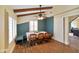 Sunlit dining area with bench seating, wood chairs, and laminate flooring at 232 N Church St, Morgantown, IN 46160