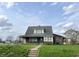 Attractive two-story home with a gray roof, a large front yard and a cozy front porch at 232 N Church St, Morgantown, IN 46160