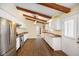 Bright kitchen featuring white cabinets, granite countertops, stainless steel appliances, and beautiful wood floors at 232 N Church St, Morgantown, IN 46160