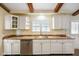 Close-up of kitchen countertops, stainless steel dishwasher, cabinets, and a window with bright natural light at 232 N Church St, Morgantown, IN 46160