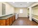 Spacious laundry room area with storage cabinets and laundry machines under recessed lighting at 232 N Church St, Morgantown, IN 46160