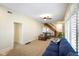 Inviting living room with plush seating, cozy carpet, and a charming staircase at 232 N Church St, Morgantown, IN 46160