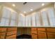 Bright office space featuring natural light from shuttered windows and built-in desk with wooden cabinets at 232 N Church St, Morgantown, IN 46160