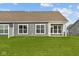 Backyard featuring a gray exterior and a well-manicured lawn at 3537 Wrangler Dr, Bargersville, IN 46106