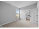 Bright bedroom with neutral carpet, open doorway to ensuite bathroom and a window view at 3537 Wrangler Dr, Bargersville, IN 46106