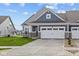 Charming home featuring a gray facade, a two-car garage, and a well-manicured front lawn at 3537 Wrangler Dr, Bargersville, IN 46106