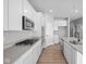 Modern kitchen with stainless steel appliances and sleek white cabinets at 3537 Wrangler Dr, Bargersville, IN 46106