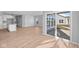 Open-concept kitchen and living space with wood-look floors and sliding glass doors at 3537 Wrangler Dr, Bargersville, IN 46106