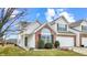 Charming two-story townhome boasts a brick facade, attached garage and well-maintained landscaping at 1463 Hamilton Dr, Greenwood, IN 46143