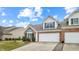 Exterior view of home with brick accents, a well-manicured lawn, and attached garages at 1463 Hamilton Dr, Greenwood, IN 46143