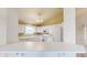 Bright kitchen with white cabinets, vaulted ceiling, and modern appliances at 1463 Hamilton Dr, Greenwood, IN 46143