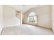 Spacious living room with natural light, vaulted ceiling, and access to the stairway at 1463 Hamilton Dr, Greenwood, IN 46143