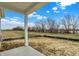 Back porch view showing a large, level lot with trees at 18425 Depoe Ln, Westfield, IN 46074