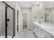 Modern bathroom featuring a glass-enclosed shower, double vanity, and sleek fixtures at 18425 Depoe Ln, Westfield, IN 46074