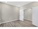 Bright bedroom with modern flooring, light gray walls, and doorways to other areas at 18425 Depoe Ln, Westfield, IN 46074