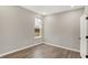 Cozy bedroom featuring a window, neutral walls, and stylish wood-look flooring at 18425 Depoe Ln, Westfield, IN 46074
