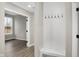 Mudroom with a coat rack and a view of the living room with natural light and wood-look flooring at 18425 Depoe Ln, Westfield, IN 46074