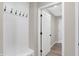 Hallway with coat rack and door leads to a room with wood-look flooring at 18425 Depoe Ln, Westfield, IN 46074