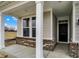 Inviting front porch with brick accents, sturdy white columns, and a view of the lawn at 18425 Depoe Ln, Westfield, IN 46074