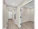 Spacious hallway featuring modern gray floors, neutral walls, and doorways into various rooms at 18425 Depoe Ln, Westfield, IN 46074