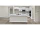 Modern kitchen with island, stainless appliances, and white cabinetry at 18425 Depoe Ln, Westfield, IN 46074