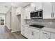 Bright kitchen features white cabinets, subway tile backsplash, stainless appliances and stone countertops at 18425 Depoe Ln, Westfield, IN 46074