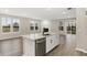 Spacious kitchen island boasts stainless dishwasher, undermount sink and stone countertops at 18425 Depoe Ln, Westfield, IN 46074