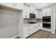New kitchen featuring white cabinets, stone countertops, stainless appliances and hardwood flooring at 18425 Depoe Ln, Westfield, IN 46074