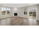Living room featuring vinyl floors, a fireplace, and sliding door to backyard at 18425 Depoe Ln, Westfield, IN 46074