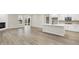 Open-concept living area with hardwood floors flowing to the kitchen with a quartz island at 18425 Depoe Ln, Westfield, IN 46074