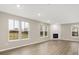 A spacious living room with hardwood floors, large windows, and a modern fireplace at 18425 Depoe Ln, Westfield, IN 46074
