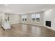 Open-concept living area with hardwood floors, a fireplace, and adjacent kitchen with an island at 18425 Depoe Ln, Westfield, IN 46074