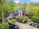 Majestic aerial view of a luxurious home with lush gardens and circular drive at 9468 Sullivan Pl, Zionsville, IN 46077