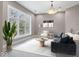Bright and airy living room with a large window showcasing the lush outdoors at 9468 Sullivan Pl, Zionsville, IN 46077