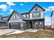 Two-story home showcasing gray siding, a two-car garage, brick accents and front porch columns at 20378 Hudson Bay Ln, Westfield, IN 46074