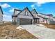 Two-story home showcasing gray siding, a two-car garage, brick accents and front porch columns at 20378 Hudson Bay Ln, Westfield, IN 46074