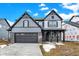 Two-story home showcasing gray siding, a two-car garage, brick accents and front porch columns at 20378 Hudson Bay Ln, Westfield, IN 46074