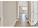 Hallway leading to the living space with wood-look floors and white trim and door frames at 20378 Hudson Bay Ln, Westfield, IN 46074